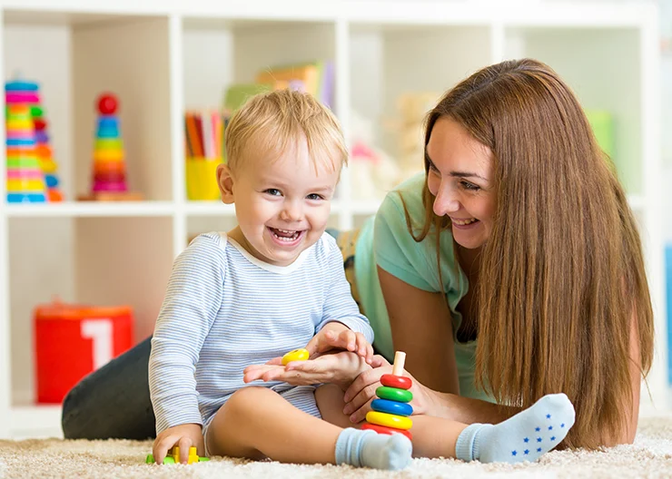 Professional babysitter helping a child with homework